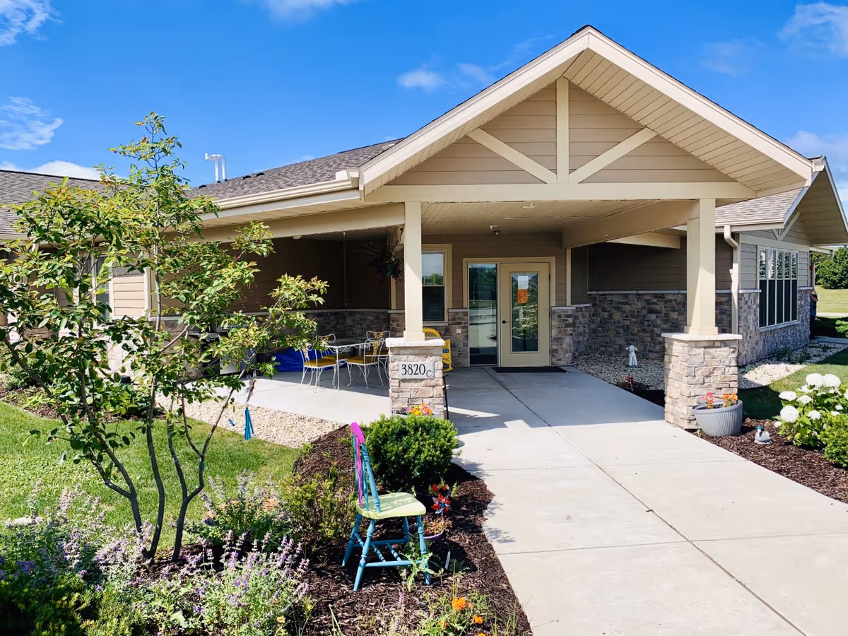 Front entrance of Magnolia Hill-Mount Pleasant Assisted Living with covered porch and landscaping.