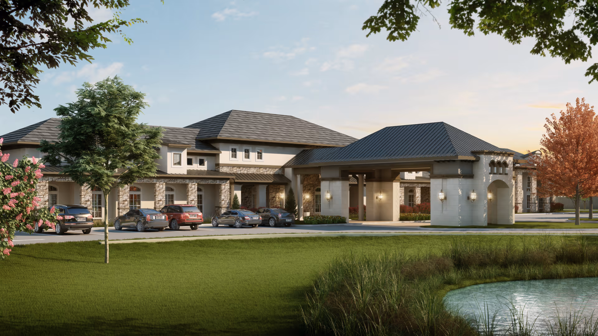 Exterior view of Pinnacle Groves facility showing a large building with stone and stucco facade, multiple cars parked in front, a covered entrance, green lawn, trees, and a small pond in the foreground under a partly cloudy sky.