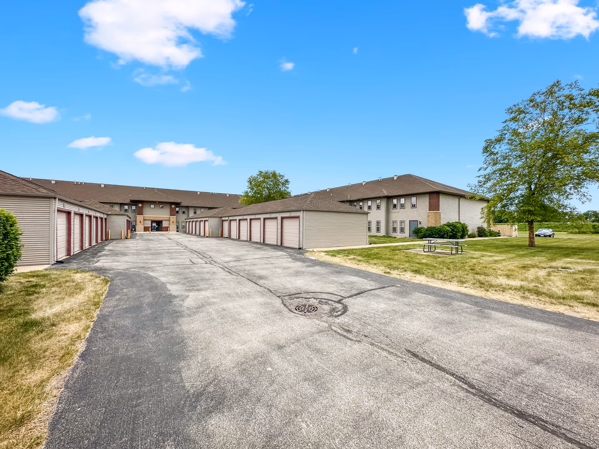 Wide driveway leads to Parkview Senior Apartments with a row of garage units.