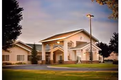 Front view of Cheney Assisted Living facility with a covered entrance and manicured lawn.