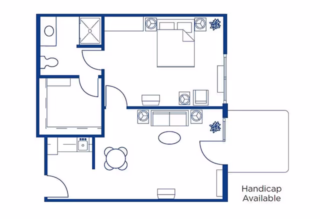 Architectural floor plan of a handicap accessible apartment unit at The Bungalows at Springfield East, showing a bedroom with a bed and nightstands, a living room with sofa and chairs, a kitchen area with stove and sink, a bathroom with toilet and shower, and an entryway.