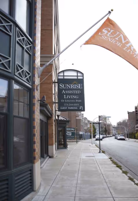 Street view of Sunrise Assisted Living at Lincoln Park, showing the building facade and sign.