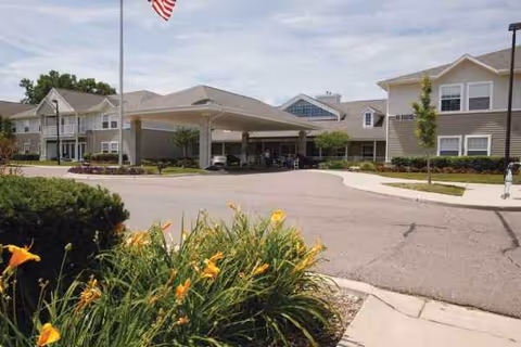Pine Ridge of Garfield exterior with covered entrance and landscaped driveway.
