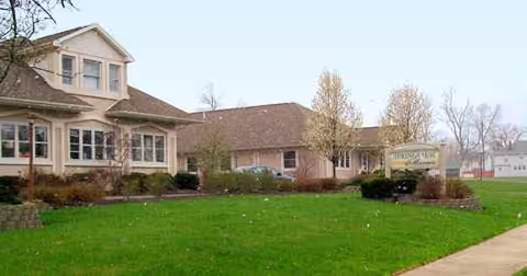 Exterior of Springview Manor senior living facility with a manicured lawn and sign.