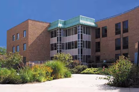 Exterior view of Fairport Baptist Homes with landscaped entrance.