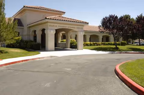 Exterior view of Oasis Nursing & Rehab entrance with arches and landscaped grounds.