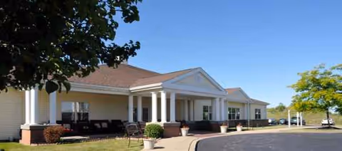 Exterior view of Celebration Villa of Chippewa, a single-story senior living facility with a covered entrance.