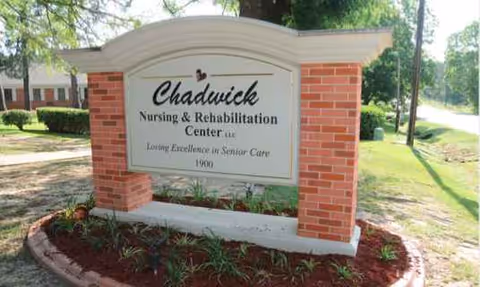 Brick sign for Chadwick Nursing and Rehabilitation Center with landscaped front yard.