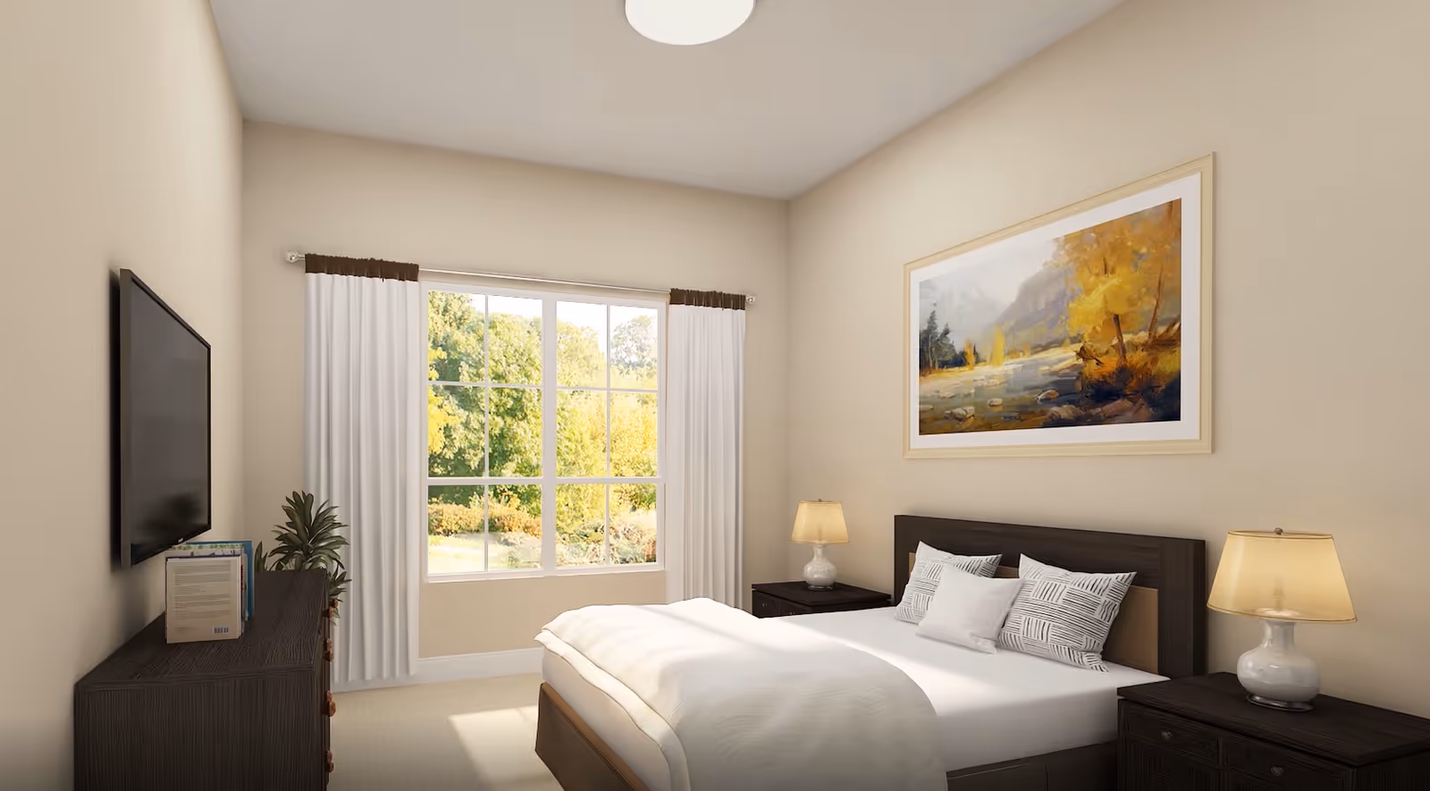 A bright bedroom with a large window showing green trees outside. The room has a bed with white bedding and patterned pillows, two dark wooden nightstands with lamps, a dark wooden dresser with books and a plant, a wall-mounted flat-screen TV, and a framed landscape painting above the bed.