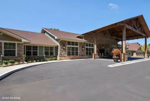 Exterior view of Cedarhurst Senior Living of Canton entrance with brick walls and a covered drop-off.