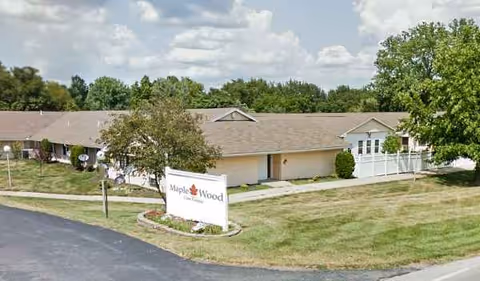 Front view of Maple Wood Healthcare Center exterior with sign and landscaping.