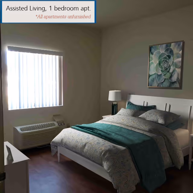 A bedroom in an assisted living facility with a neatly made bed featuring patterned bedding and a teal throw blanket. There is a nightstand with a lamp beside the bed, a framed succulent artwork on the wall, a window with vertical blinds, and an air conditioning unit below the window. A sign in the top left corner reads 'Assisted Living, 1 bedroom apt. *All apartments unfurnished'.