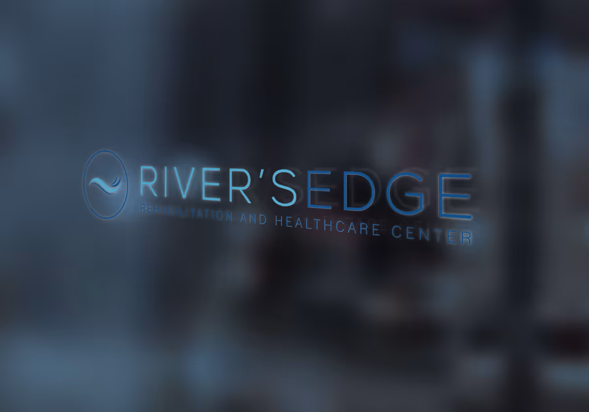 A frosted glass door or window displaying the illuminated 'RIVER'S EDGE Rehabilitation and Healthcare Center' logo with a blurred interior behind it.
