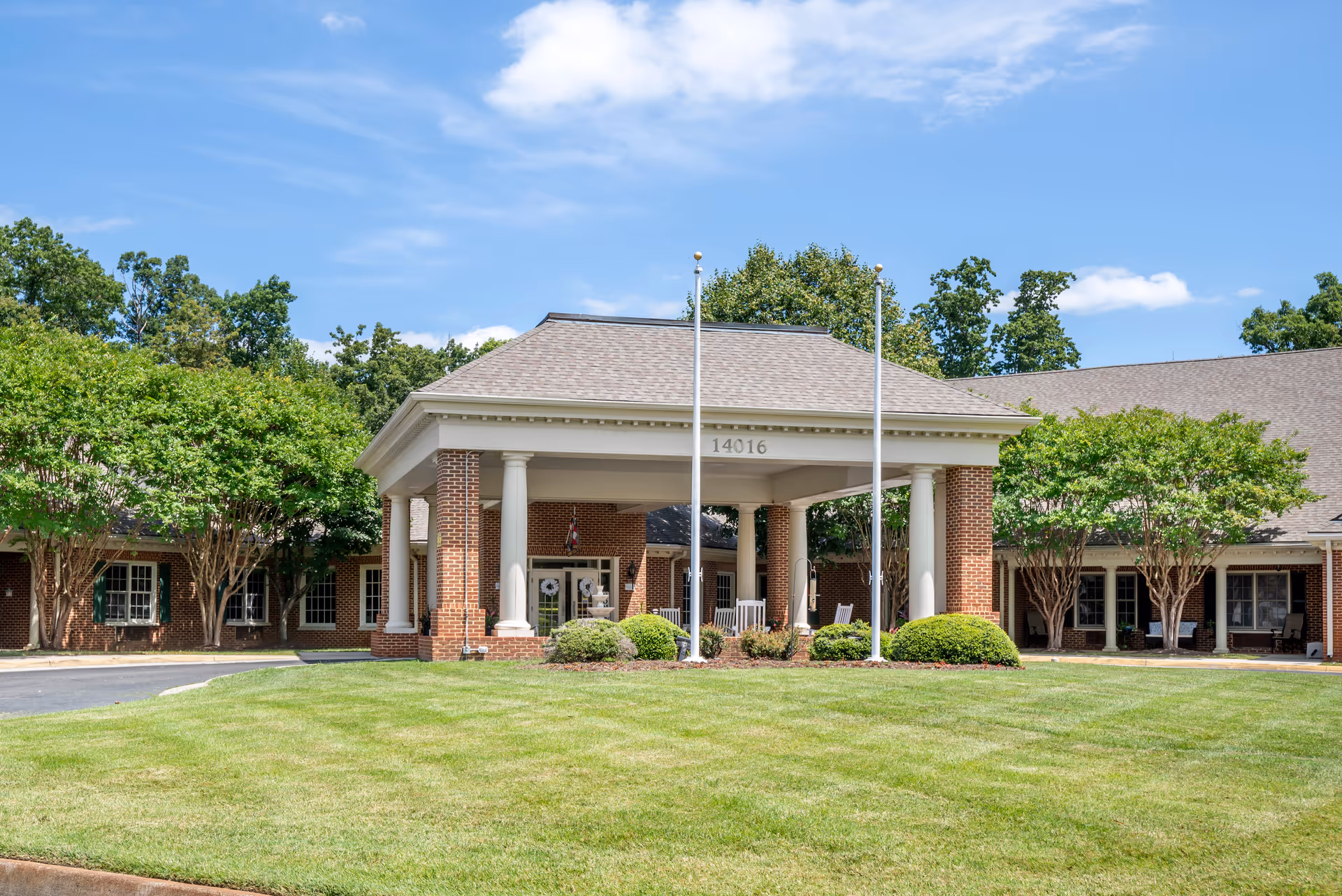 Brookdale Midlothian senior living facility exterior with a covered entrance, columns, and manicured lawn.