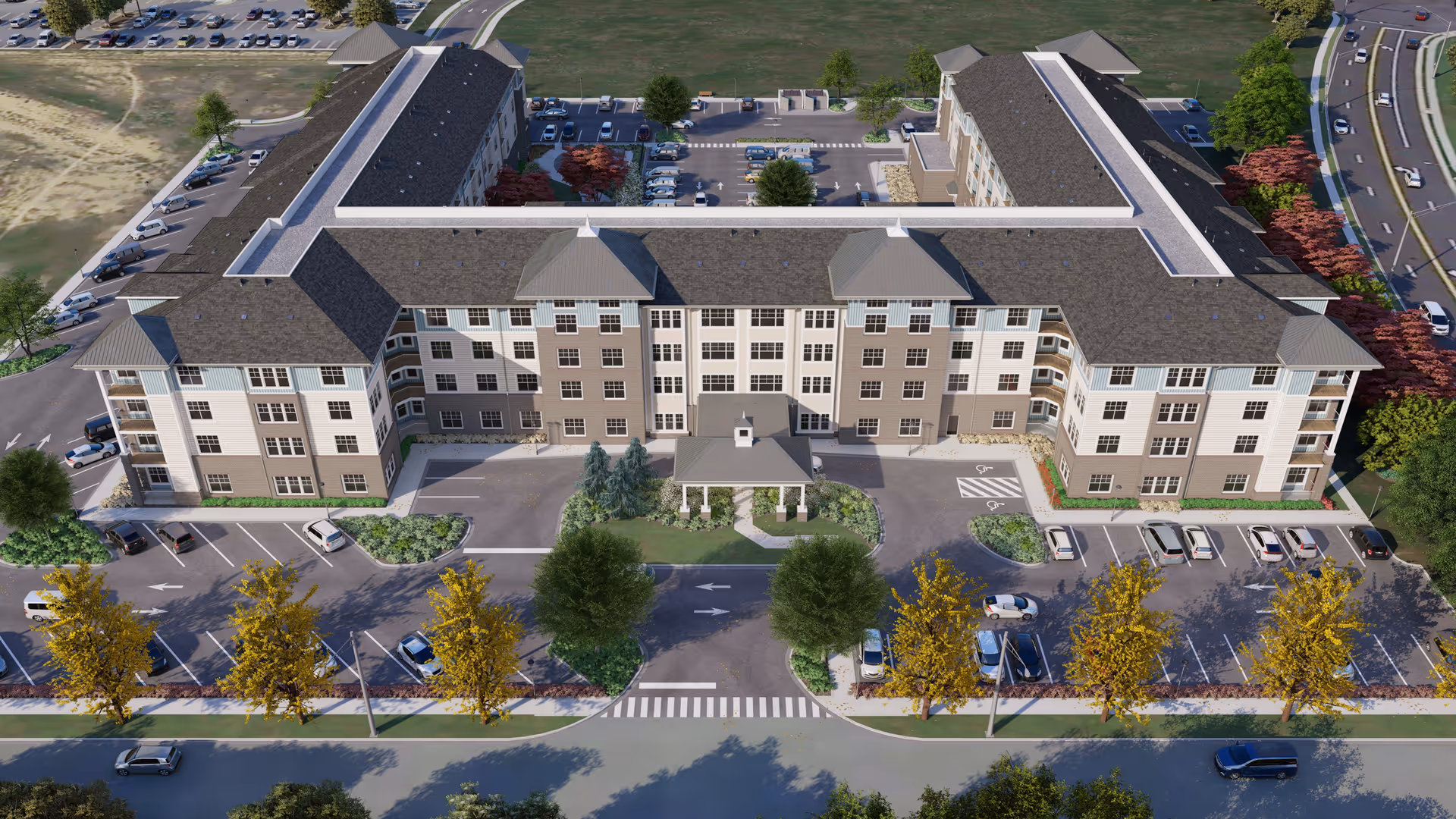 Aerial view of a large senior living facility named Acclaim at the Hill, showing a multi-story building with a central entrance, surrounded by parking lots, trees, and landscaped areas.