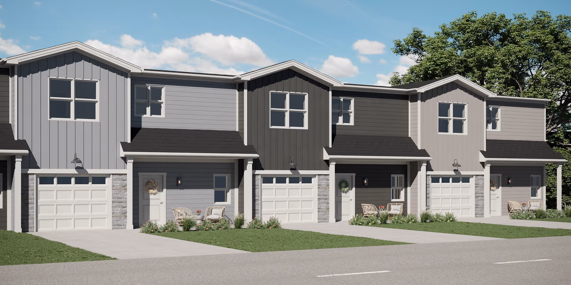 Row of modern two-story attached townhome units with garages, small front porches, and driveways under a blue sky.