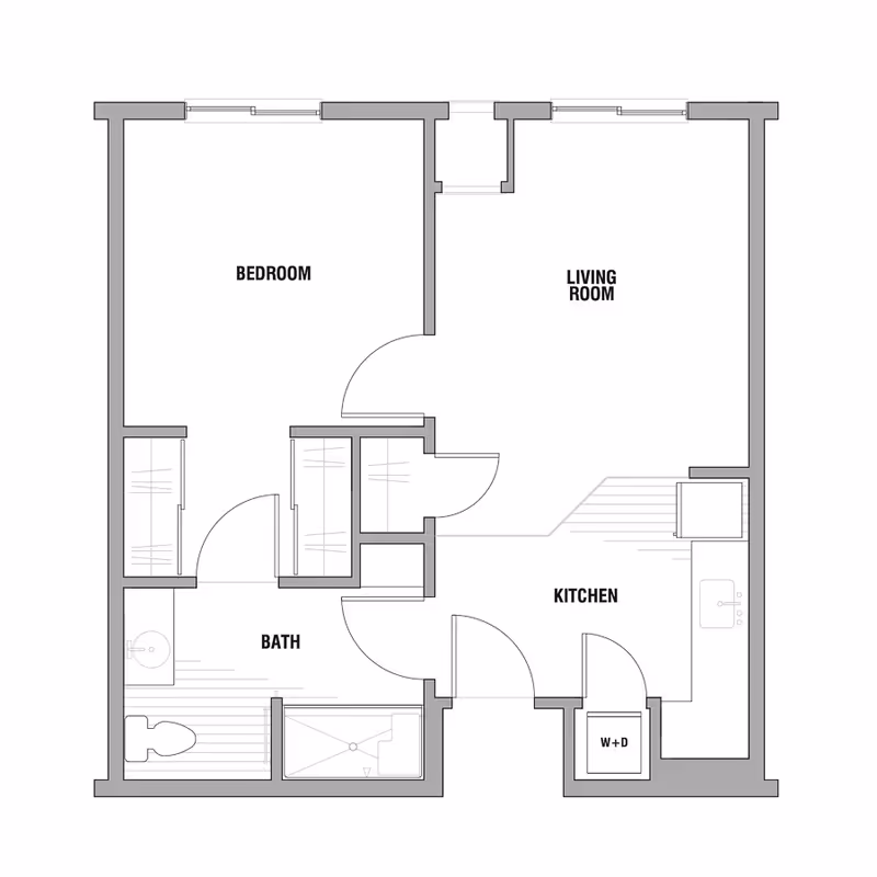 Architectural floor plan of a one-bedroom assisted living unit showing a bedroom, living room, kitchen, bathroom, and a washer-dryer area.