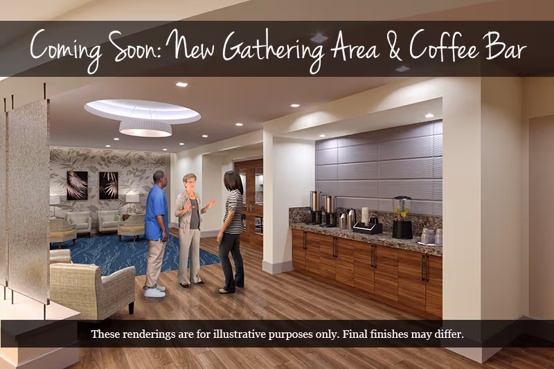 Three people talking in a furnished interior gathering area with seating and a coffee bar.