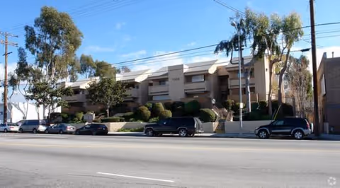 Exterior view of Lankershim Arms senior living building along a street.