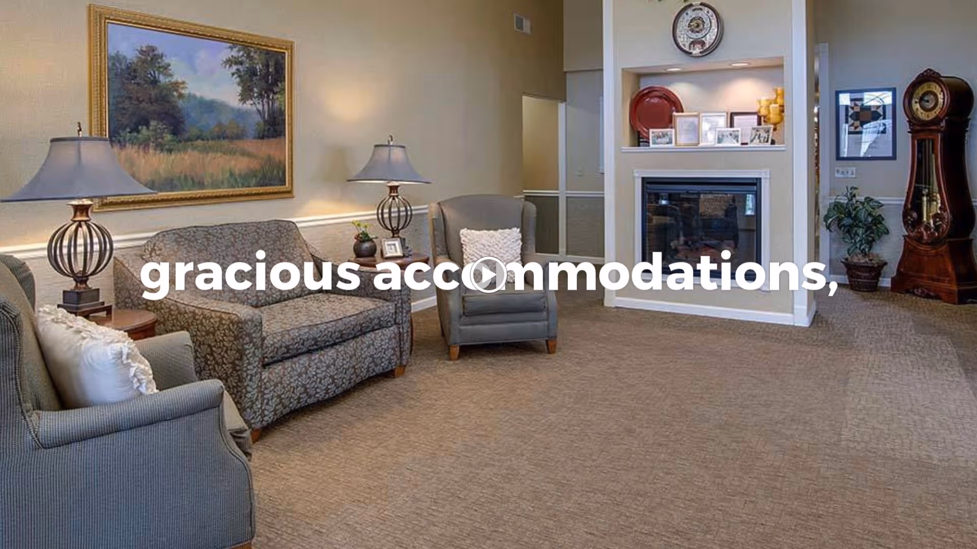 A cozy senior living common area with upholstered sofas and armchairs, lamps, a fireplace, wall art, and a grandfather clock.