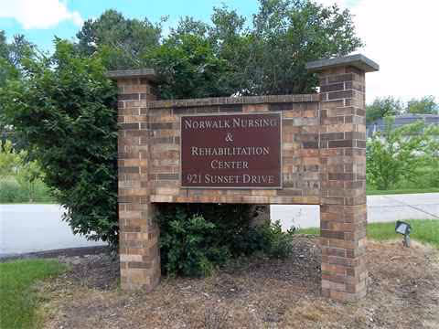 Brick sign for Norwalk Nursing & Rehabilitation Center at the entrance.