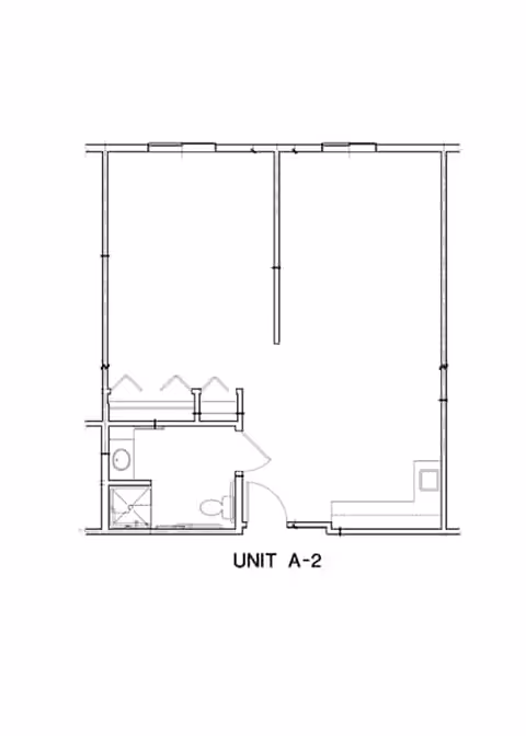 Black-and-white floor plan labeled "UNIT A-2" showing a small apartment layout with a bathroom, entry door, and open living area.
