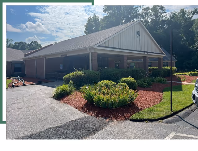 Front view of Laurel Park Rehabilitation and Healthcare Center with a brick entrance and landscaping.
