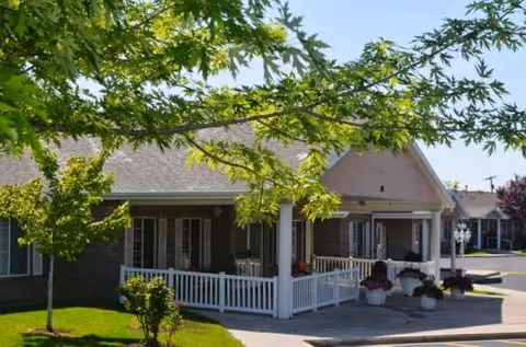 Canyon Breeze Senior Living facility exterior with a covered porch and trees