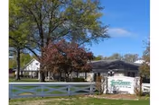 Exterior view of Fern Terrace Lodge of Murray with a white fence and sign.