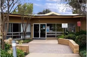 Villa Del Rio Convalescent Center front entrance with glass doors and greenery