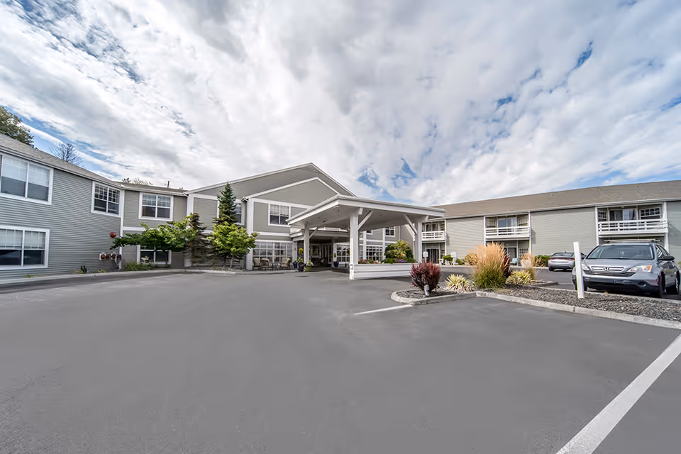 Exterior view of Brookdale Hearthstone Moses Lake showing entrance canopy and parked cars
