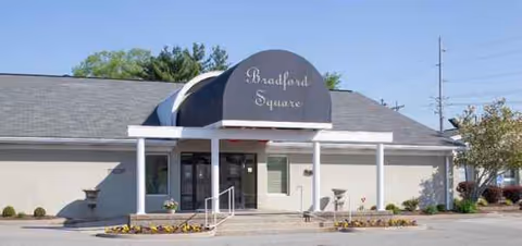 Bradford Square senior living facility front entrance with sign and landscaping.