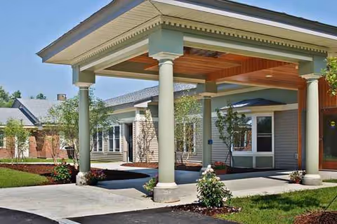 Exterior view of Oak Grove Center with a covered entrance and columns.
