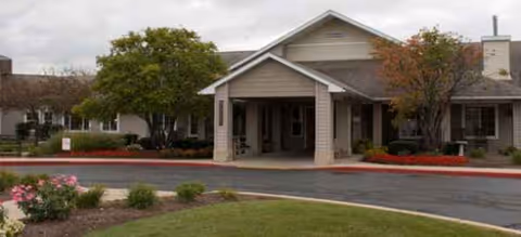 Front view of Rock Run Memory Care entrance, a single-story senior living facility with landscaping.