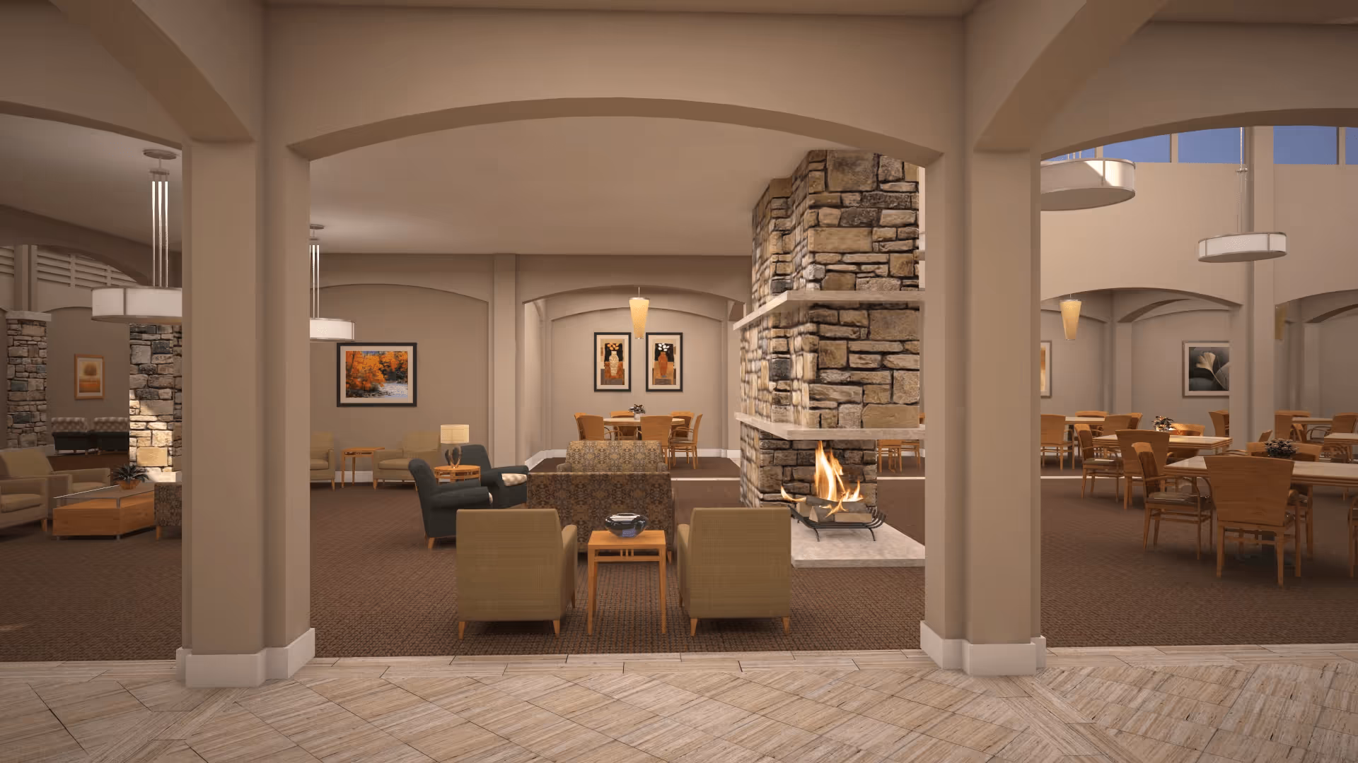 A spacious senior living common area featuring a stone fireplace with a fire burning, surrounded by comfortable armchairs and sofas. The room has beige walls with arched openings, carpeted floors, and several dining tables with wooden chairs. The space is decorated with framed artwork and modern pendant lights hanging from the ceiling.