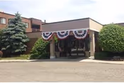 Front entrance of Franklin Terrace Independent and Assisted Living with patriotic bunting decorations.
