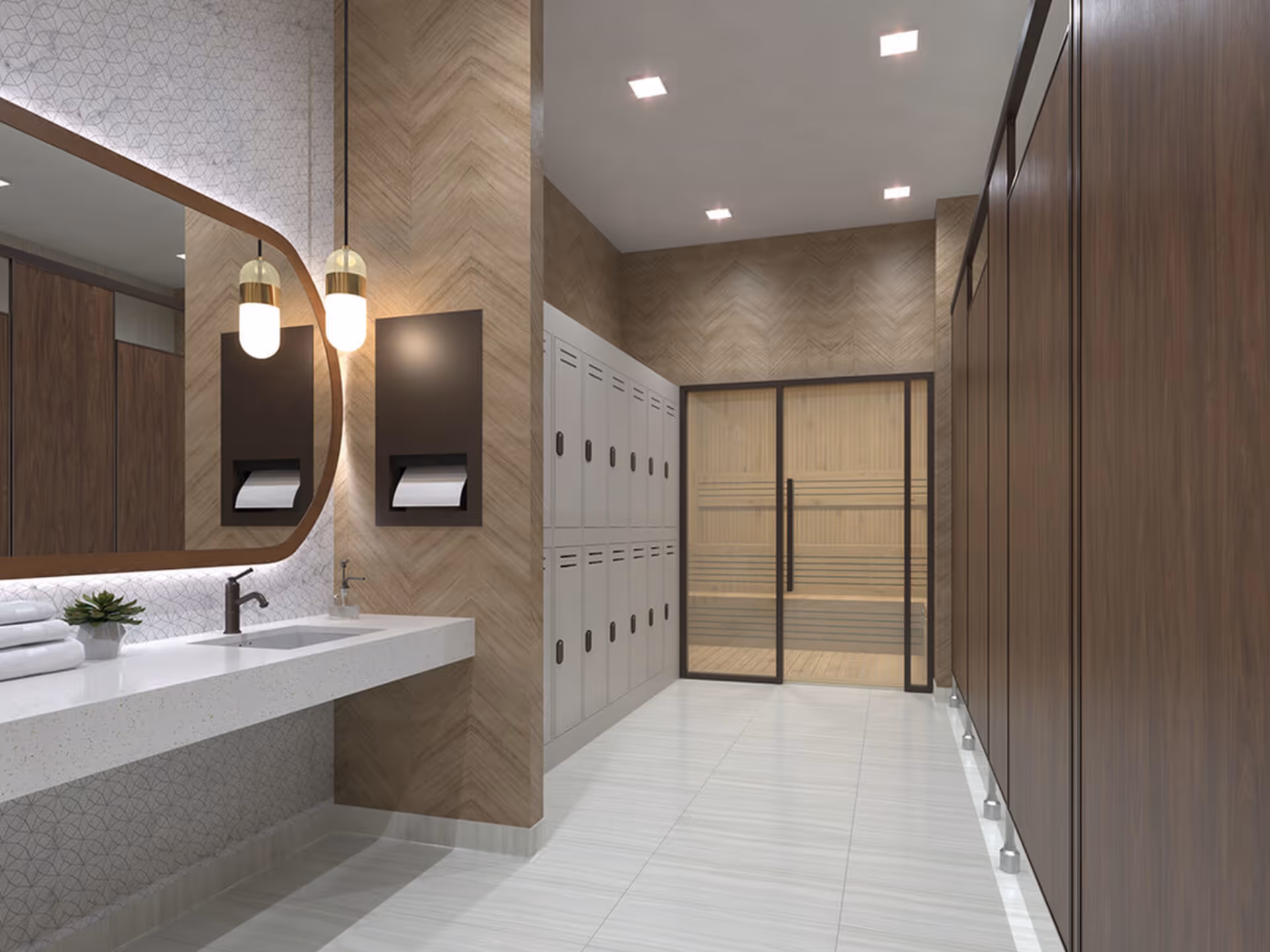 Modern locker room with wooden lockers on the right and white lockers on the left. There is a white countertop with a sink, a large mirror with rounded corners, two hanging pendant lights, and a soap dispenser. At the end of the room, there is a glass door leading to a wooden sauna.