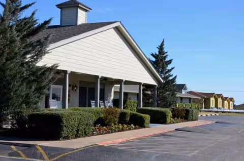 Front view of a single-story Senior Care of Marlandwood East building with a covered porch.