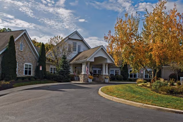 An exterior view of Buckingham Heights Memory Care with landscaped surroundings and a welcoming entrance.
