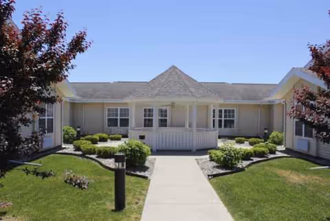 Single-story senior living facility with central entrance and manicured front landscaping.
