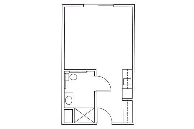 Architectural floor plan showing a layout with a bathroom including a toilet, sink, and shower, adjacent to a larger open space with a kitchen area featuring a sink and counter space.
