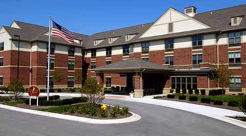 Exterior view of Victory Centre of Sierra Ridge with brick facade and flag at entrance.
