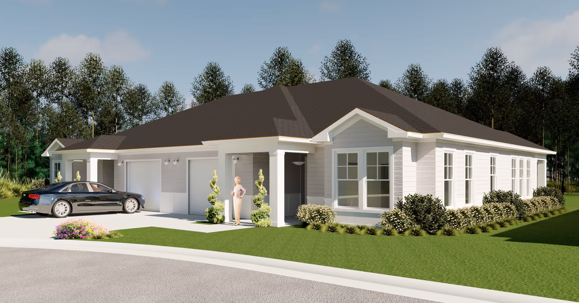 Exterior view of a single-story residential building with a dark roof, light-colored siding, multiple windows, and a two-car garage. A black car is parked in the driveway, and an elderly woman stands near the entrance. The building is surrounded by green grass, bushes, and trees in the background under a partly cloudy sky.