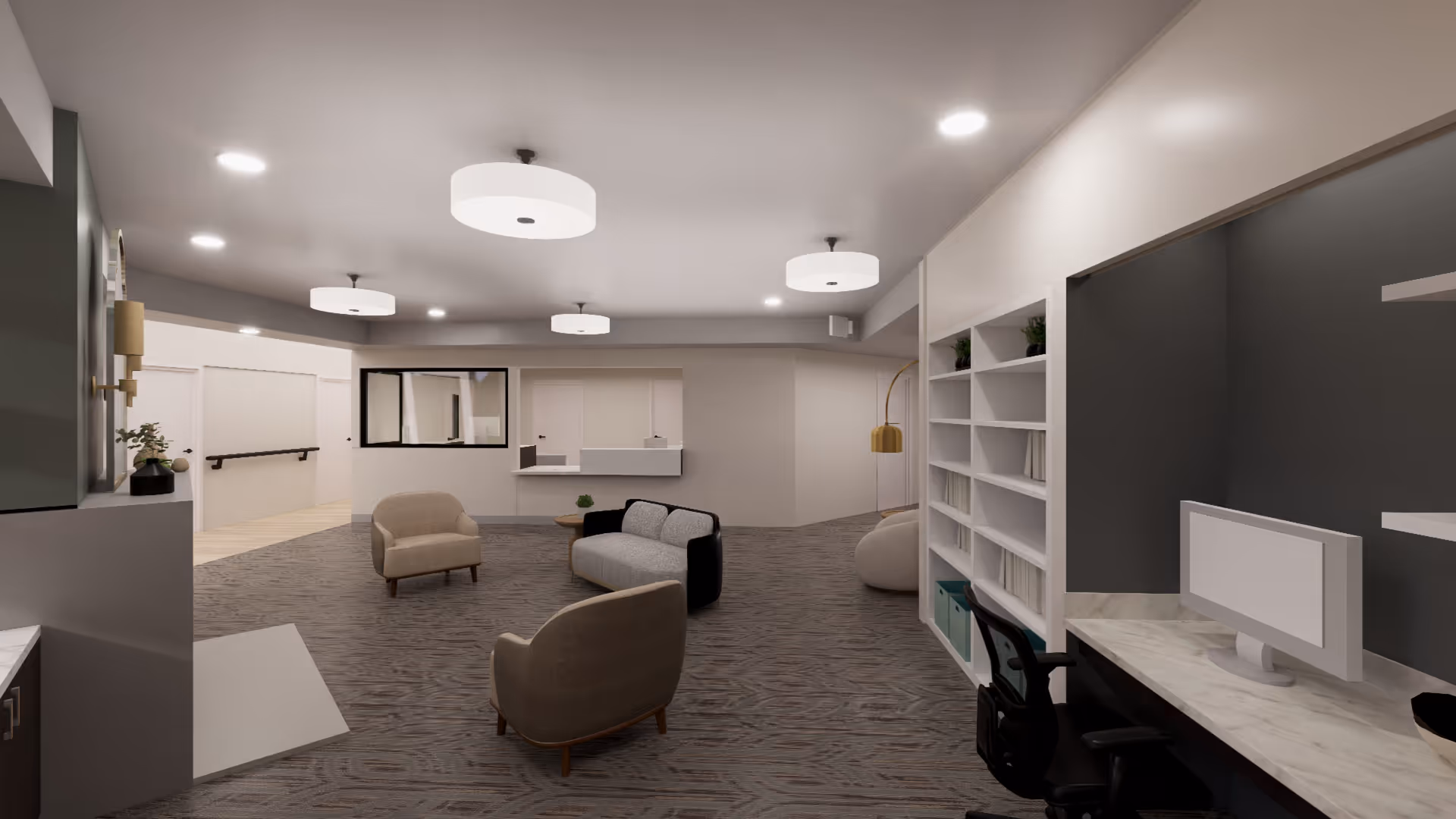 A modern and spacious interior common area with neutral tones, featuring a seating arrangement with two armchairs and a small sofa around a coffee table. There is a reception window on the far wall, built-in white shelving with books and plants on the right, and a desk with a computer monitor and office chair. The space is well-lit with ceiling lights and has a carpeted floor.