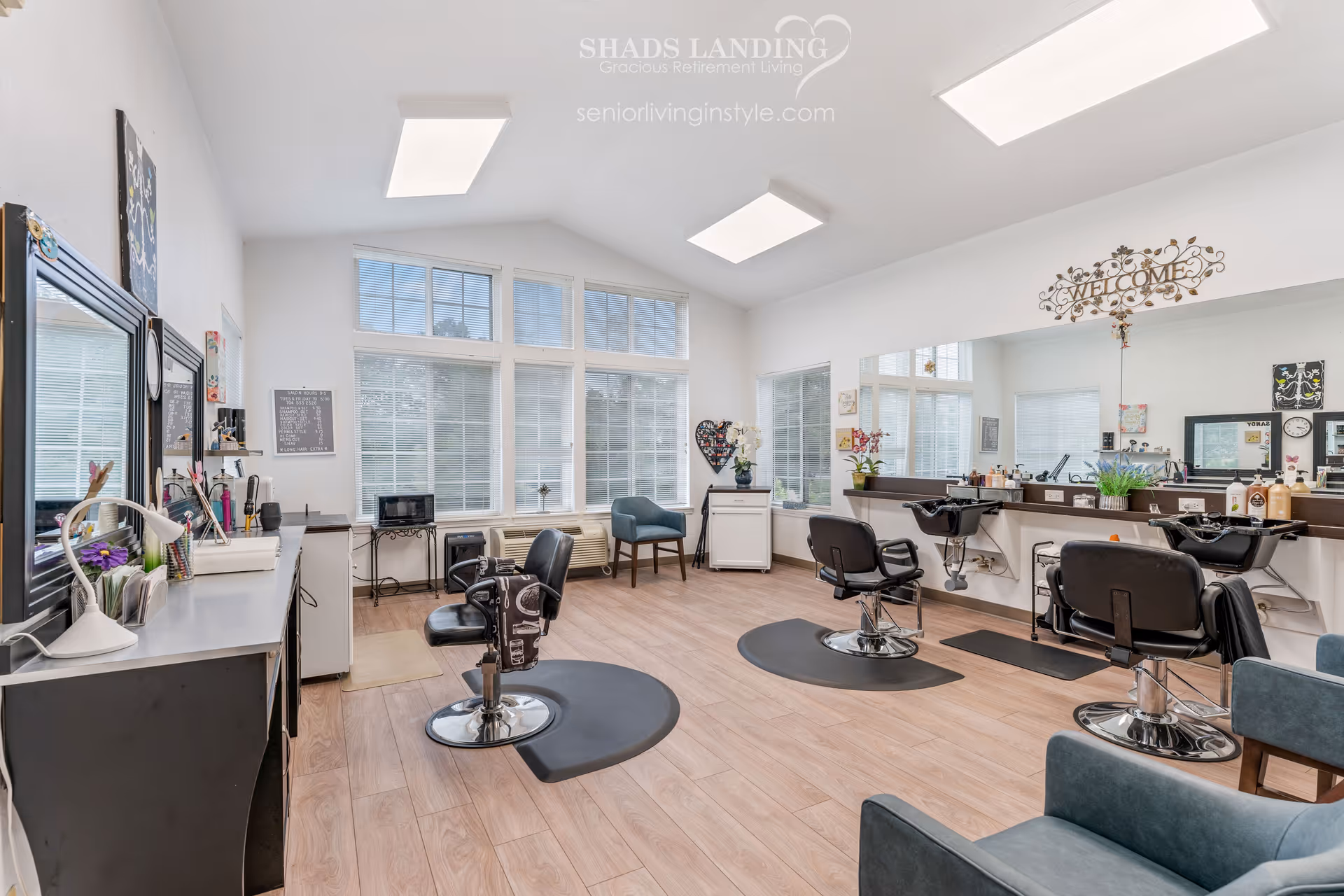 Bright hair salon in a senior living facility with styling chairs, mirrors, and large windows.