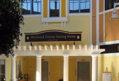 Front exterior of Merrimack County Nursing Home with a covered entrance and sign.