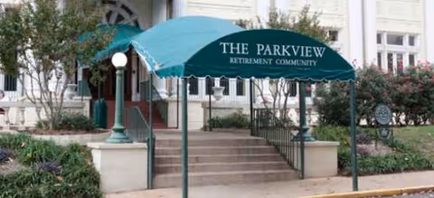 The Parkview retirement community entrance with a teal canopy over steps.