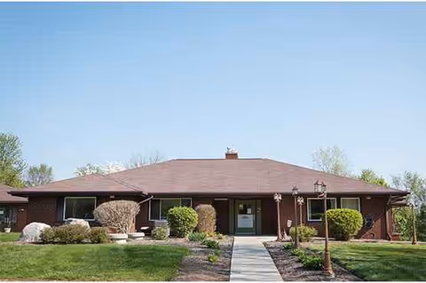 One-story brick building with a central entrance and well-kept landscaping.