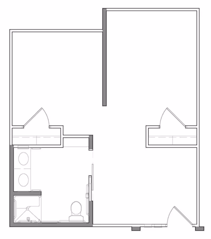 Architectural floor plan showing a layout with two rooms, a bathroom with a shower, toilet, and double sink, and closets in each room.