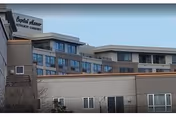 Exterior view of Capital Manor Retirement Community building with a sign on the front.